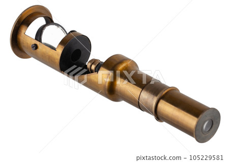 Vintage brass microscope. Small hand microscope from the 20th century. Vintage brass microscope. Small hand microscope from the 20th century. 105229581