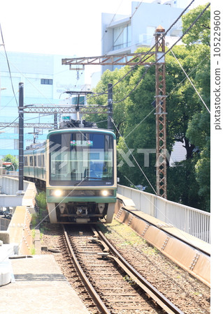 Enoden, a local train running between houses Enoden, a local train running between houses 105229600