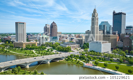 Skyscraper view of downtown Columbus Ohio with green part and driving bridge aerial 105229621