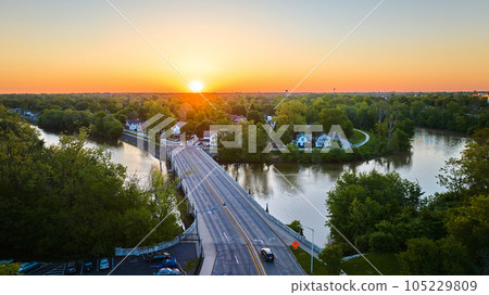 Horseshoe riverbend aerial small town with bridge over water at sunrise sunset landscape village Horseshoe riverbend aerial small town with bridge over water at sunrise sunset landscape village 105229809
