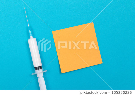 Vaccination or Revaccination Concept - A Medical Syringe on Blue Table 105230226