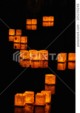 Japanese style lanterns floating in S formation on black pond Japanese style lanterns floating in S formation on black pond 105230248