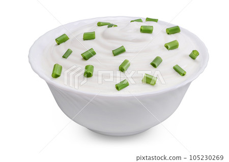 sour cream or yogurt in ceramic bowl with green onion isolated on white background with full depth of field 105230269