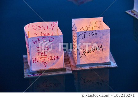 Funny themed Japanese lantern pair on still water Funny themed Japanese lantern pair on still water 105230271