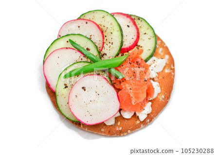Cracker Sandwich with Salmon, Cucumber, Radish, Cottage Cheese and Green Onions - Isolated 105230288