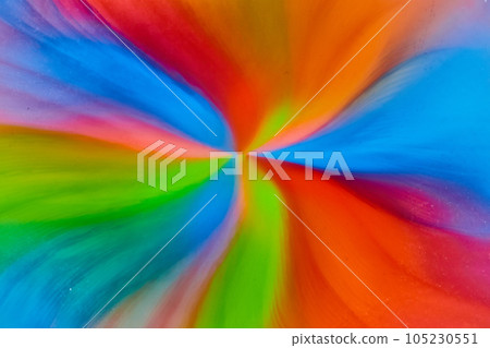 Psychedelic hippie flowing flower from water and color from skittles rainbow sugar candy 105230551