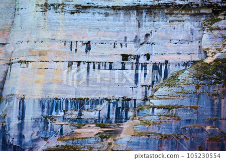 Background Pictured Rocks with minerals dripping like paint down stone cliff face Background Pictured Rocks with minerals dripping like paint down stone cliff face 105230554