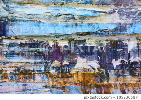 Cliff wall background with blue, black, and rust colored stone at Pictured Rocks National Park 105230587