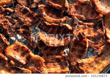 Cooking tasty meat slices at bbq grill backyard Grilling tenderloin on charcoal. steaks on the grill 105230673