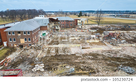 Destroyed building with boarded up windows and debris on the ground Destroyed building with boarded up windows and debris on the ground 105230724