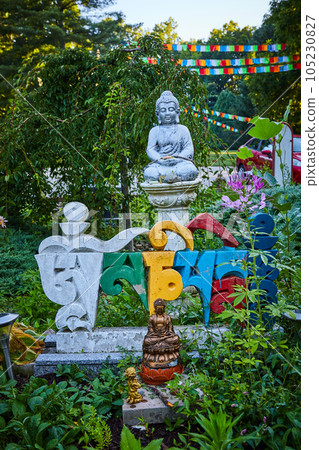 Foreign colorful letters and Buddha statues in prayer and meditation garden for Tibetan Mongolian Buddhist shrine 105230827
