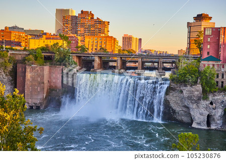 Rochester New York stunning natural waterfall next to downtown skyline at sunset 105230876