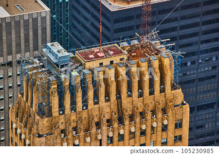 Looking down on top of large stone skyscraper under construction in New York City Manhattan in golden light 105230985
