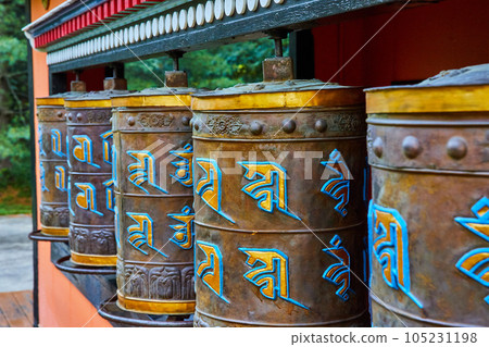 Ornate prayer wheels in detail at Tibetan Mongolian Buddhist shrine Ornate prayer wheels in detail at Tibetan Mongolian Buddhist shrine 105231198