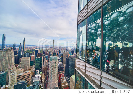 High up skyscraper outside wall and inside of metal balls with view of New York City skyline outside 105231207