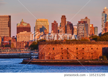 Governors Island Castle Williams from waters in New York City golden hour sunset light 105231295
