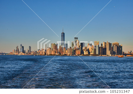 Stunning southern Manhattan island from ferry with soft golden light Stunning southern Manhattan island from ferry with soft golden light 105231347