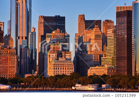 Golden light over New York City skyscrapers in detail from off coast of southern Manhattan 105231399
