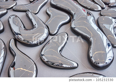 Ground covered in large melted reflecting metal shapes in exhibit Ground covered in large melted reflecting metal shapes in exhibit 105231530