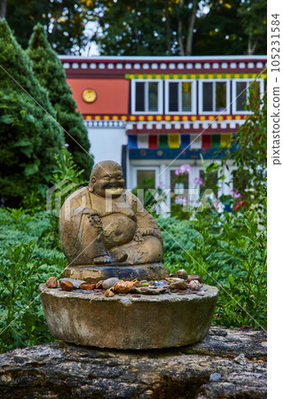 Small Buddha statue outside of shrine in Indiana 105231584