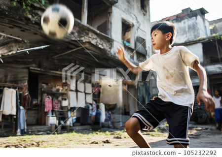 Chinese boy play football on the backyard in asian city 105232292