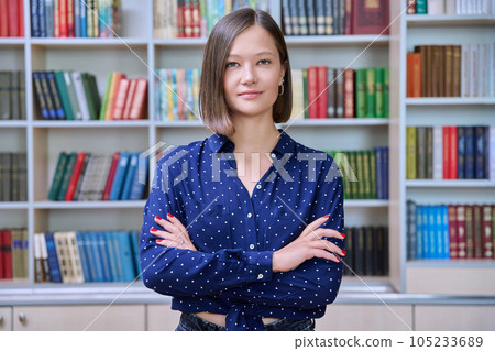 Portrait of confident female college student inside library in educational building Portrait of confident female college student inside library in educational building 105233689