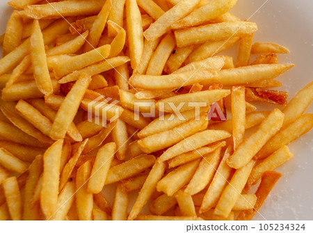 Fried fries on a white plate. Yummy French fries, a quick meal. High quality photo Fried fries on a white plate. Yummy French fries, a quick meal. High quality photo 105234324