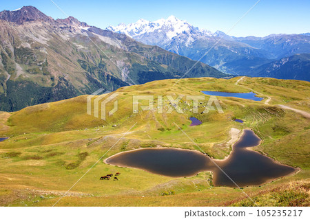 mountain lake in the snowy backdrop of the Caucasus mountain range in Georgia 105235217