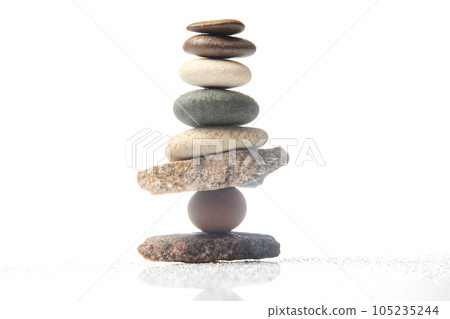 pyramid of stacked stones on a white background. stabilization and balance in life 105235244