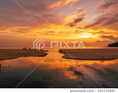.aerial view stunning reflection of bright golden sky in a canal at Karon beach Phuket. .aerial view stunning reflection of bright golden sky in a canal at Karon beach Phuket. 105235641