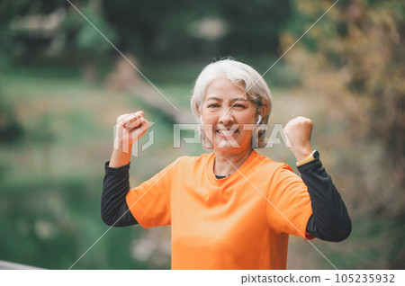 white-haired elderly person exercising in the park early in the morning. white-haired elderly person exercising in the park early in the morning. 105235932