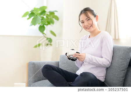 A woman reminiscing while looking at the camera screen A woman reminiscing while looking at the camera screen 105237501