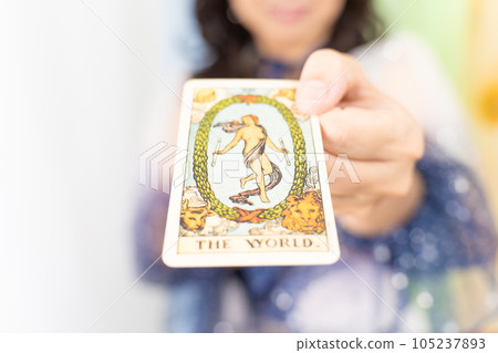A fortune teller presenting a tarot card (THE WORLD) A fortune teller presenting a tarot card (THE WORLD) 105237893