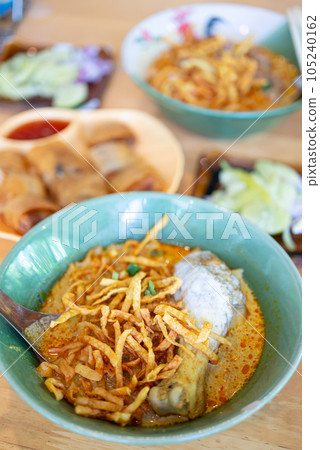 Northern Thai food (Khao Soi), Spicy curry noodles soup with chicken, Local Thai food Northern Thai food (Khao Soi), Spicy curry noodles soup with chicken, Local Thai food 105240162