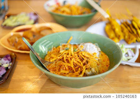 Northern Thai food (Khao Soi), Spicy curry noodles soup with chicken, Local Thai food Northern Thai food (Khao Soi), Spicy curry noodles soup with chicken, Local Thai food 105240163