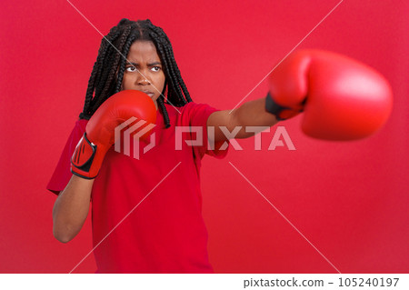 African woman doing shadow boxing with gloves 105240197