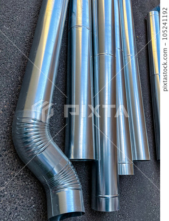 Steel downpipes stacked on the ground. High quality photo 105241192