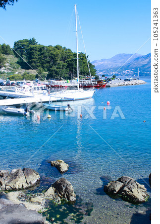 White yacht in Cavtat bay. Blue sky, clean water. White yacht in Cavtat bay. Blue sky, clean water. 105241363
