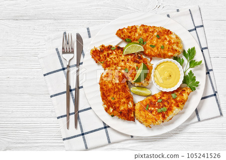 fried chicken cutlets on white plate, top view 105241526