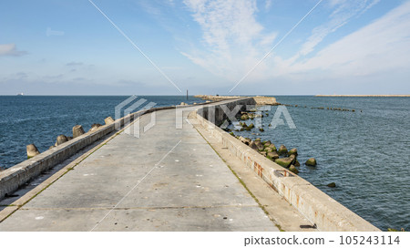Southern long concrete pier with breakwaters on the Baltic Sea on the Vistula Spit. Baltiysk. Russia Southern long concrete pier with breakwaters on the Baltic Sea on the Vistula Spit. Baltiysk. Russia 105243114