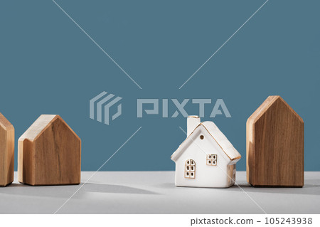 Real estate business concept. Office desk with a white and wooden houses. timber costs copy space banner. Loan or insurance rate payments. Liability and risk. Neighborhood community compound choice Real estate business concept. Office desk with a white and wooden houses. timber costs copy space banner. Loan or insurance rate payments. Liability and risk. Neighborhood community compound choice 105243938