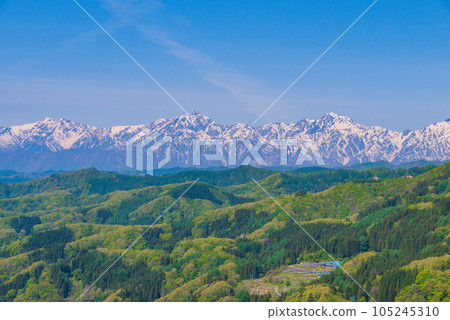 Nagano Prefecture Kinasa with its fresh greenery and the mountains of the Tateyama mountain range after the remaining snow Nagano Prefecture Kinasa with its fresh greenery and the mountains of the Tateyama mountain range after the remaining snow 105245310