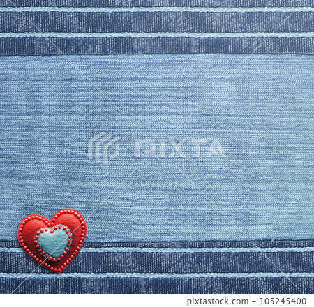 Blue denim background with striped borders and red felt heart. Navy color denim jeans fabric texture. Valentine's day denim backdrop Blue denim background with striped borders and red felt heart. Navy color denim jeans fabric texture. Valentine's day denim backdrop 105245400