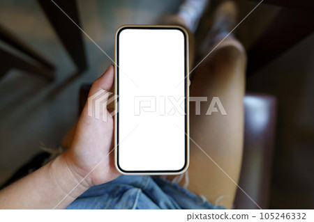 Close up of women's hands holding cell telephone blank copy space screen. smart phone with technology concept Close up of women's hands holding cell telephone blank copy space screen. smart phone with technology concept 105246332