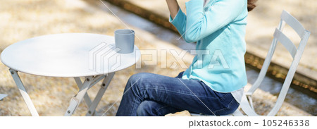 Woman hands holding cup of coffee in the park Woman hands holding cup of coffee in the park 105246338