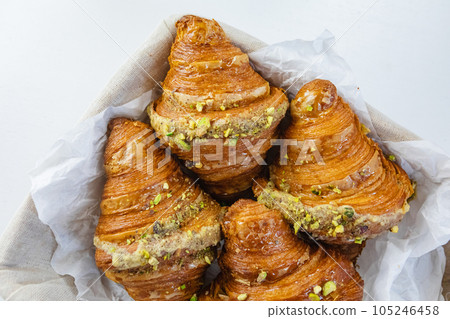 Rustic basket of croissants on white table 105246458