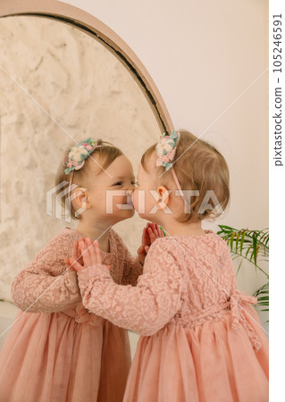 cute smiling toddler girl near mirror cute smiling toddler girl near mirror 105246591