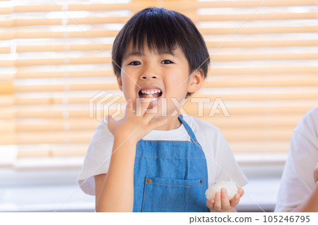 boy eating rice ball boy eating rice ball 105246795