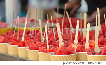 Cups with sliced portions of watermelon ready to be sold in the stall at the Naplavka farmers market 105246876