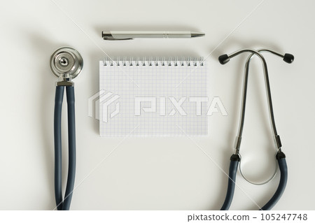 Stethoscope and notebook with pen isolated on white background. 105247748